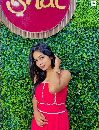 Editorial portrait of a red pleated dress from Ishal Dresses